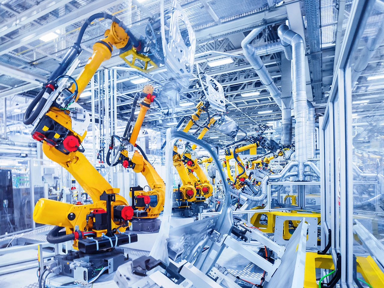 Yellow robots manufacture cars 