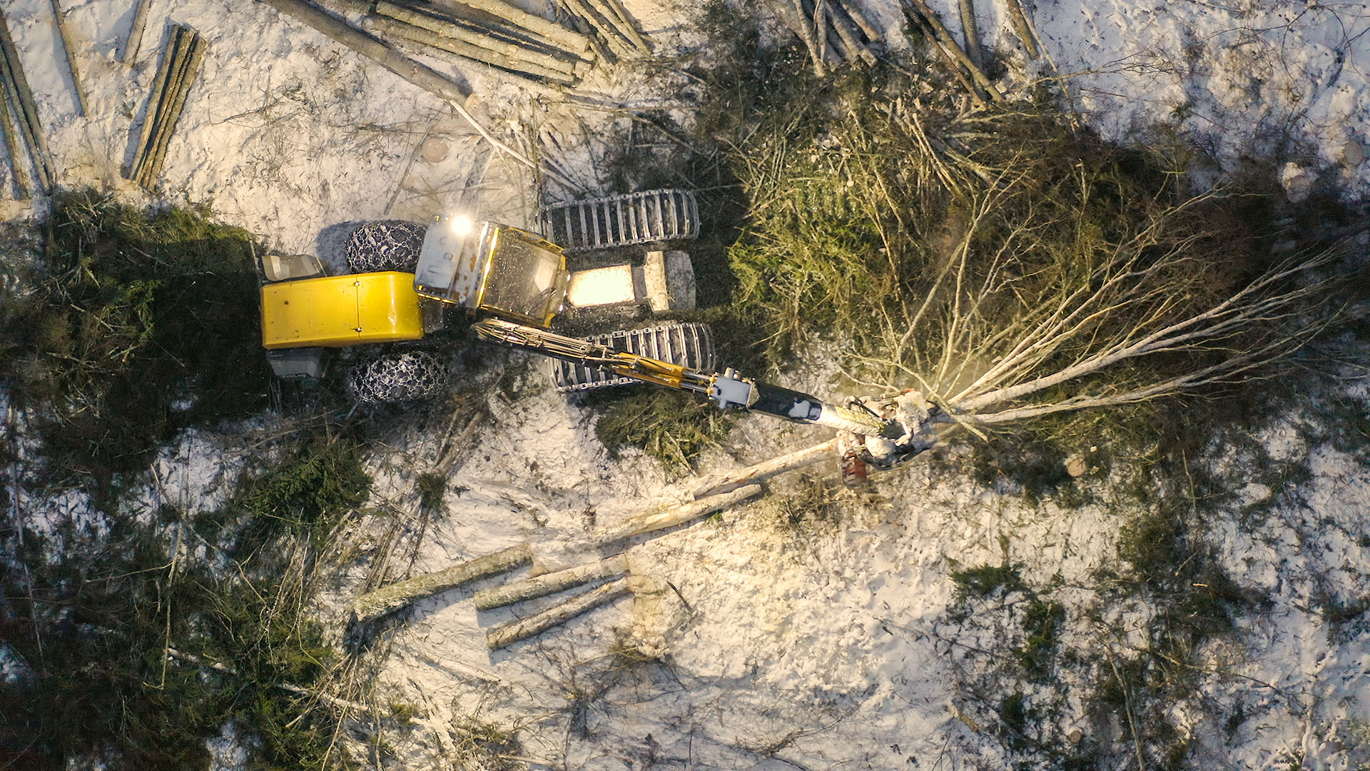 Aerial view of a harvester in the snow