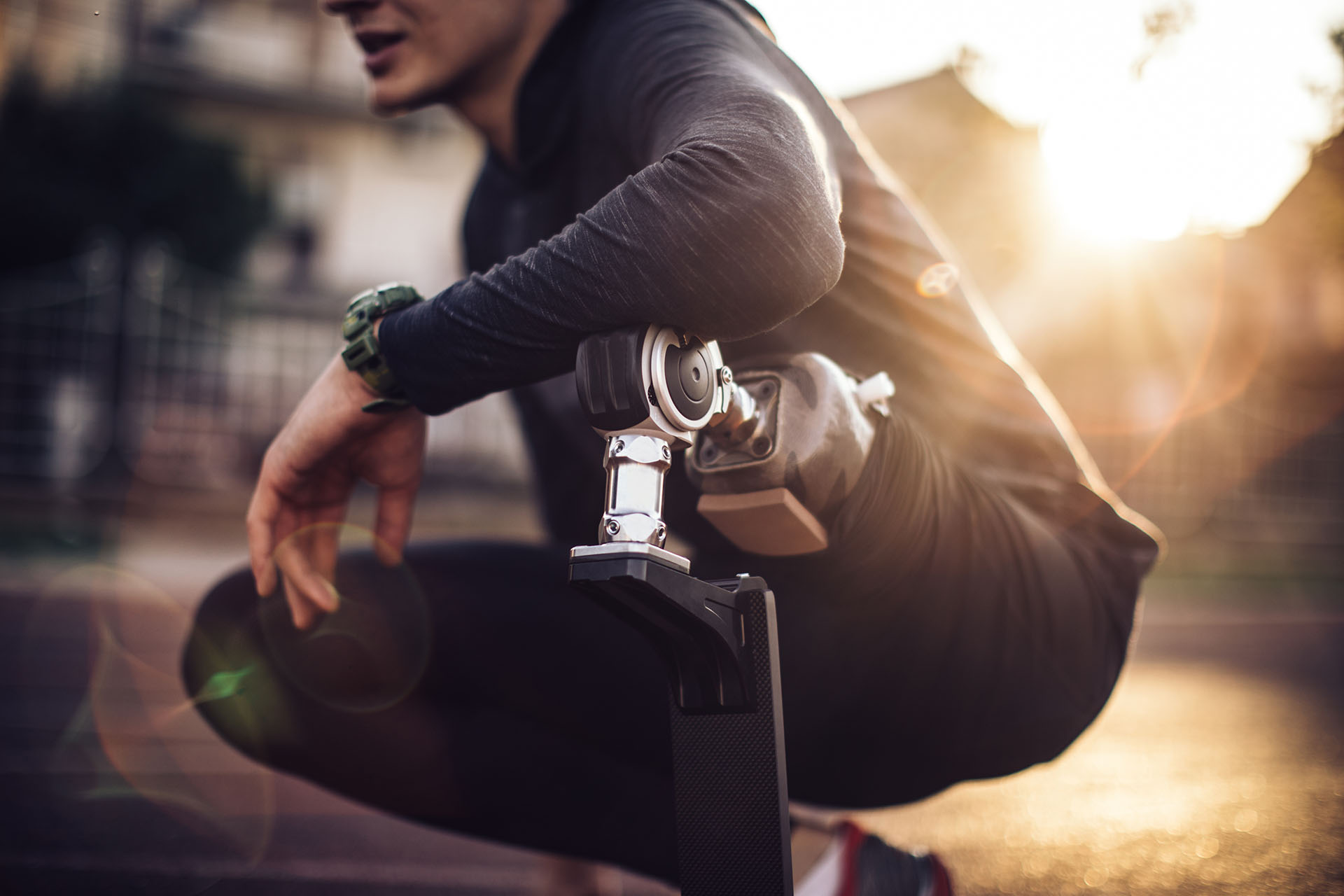 Man with prosthetic leg squats on the ground