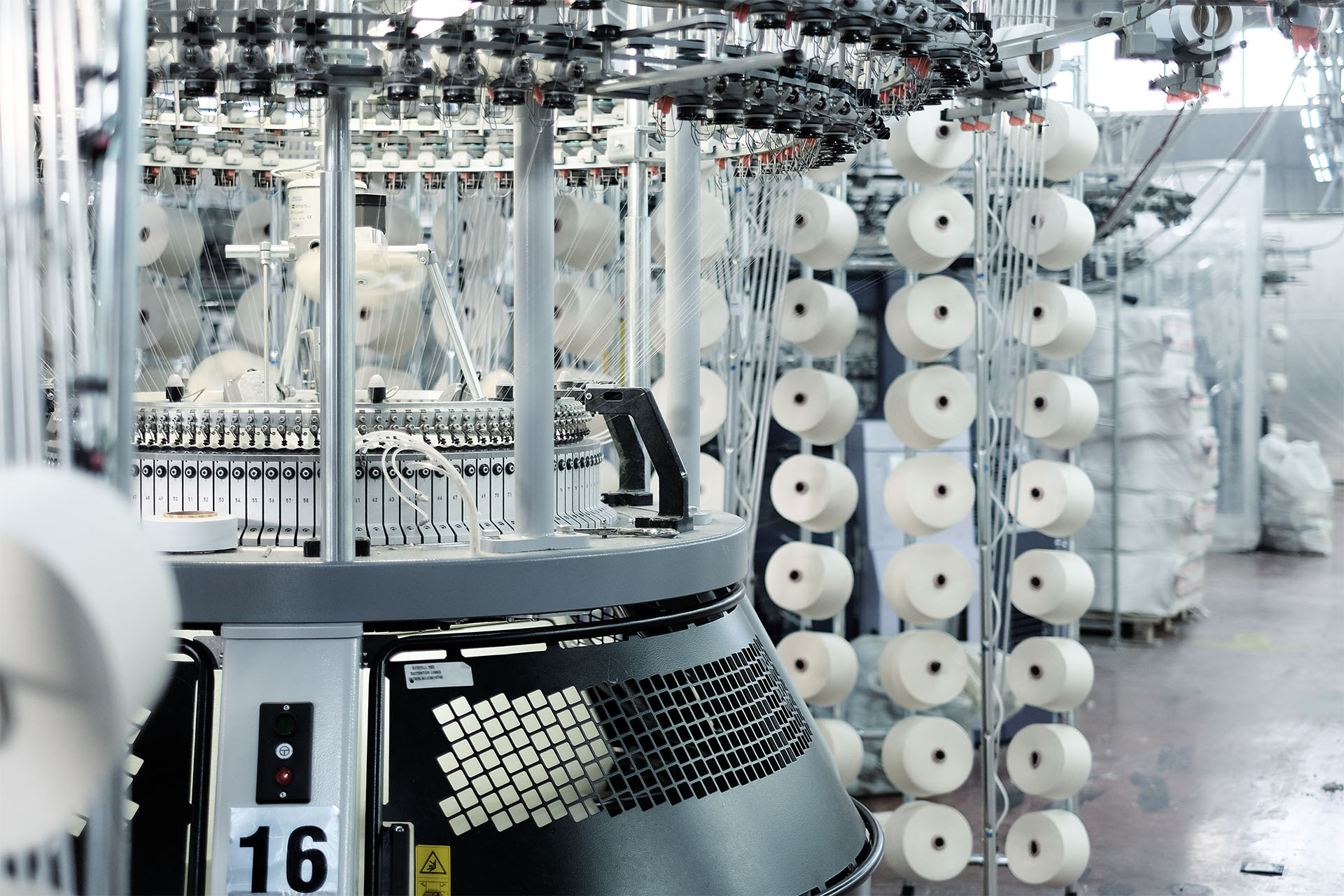 Circular and flatbed knitting machines in the textile industry.